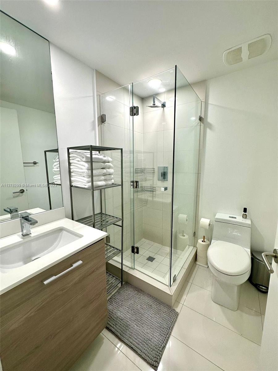 Brickell Miami, FL 33130 - Photo 13 of 17 a spacious bathroom with a shower sink mirror and toilet