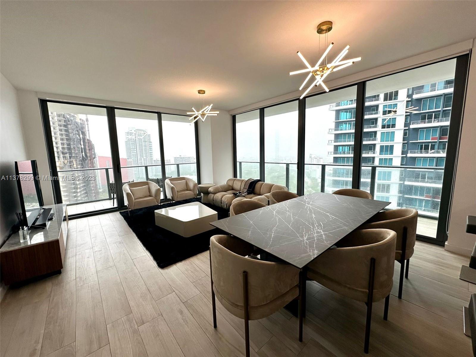 Brickell Miami, FL 33130 - Photo 3 of 17 a view of a dining room with furniture and wooden floor