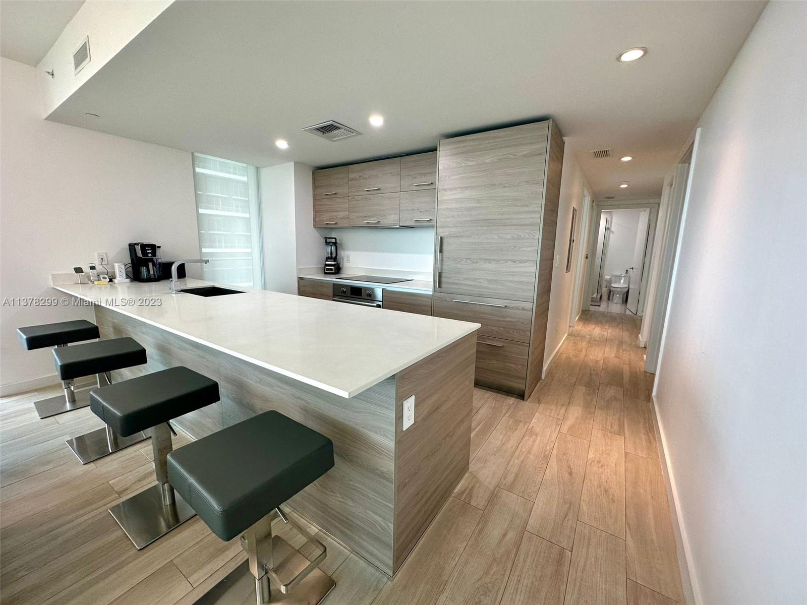 Brickell Miami, FL 33130 - Photo 4 of 17 a kitchen with a sink appliances and cabinets