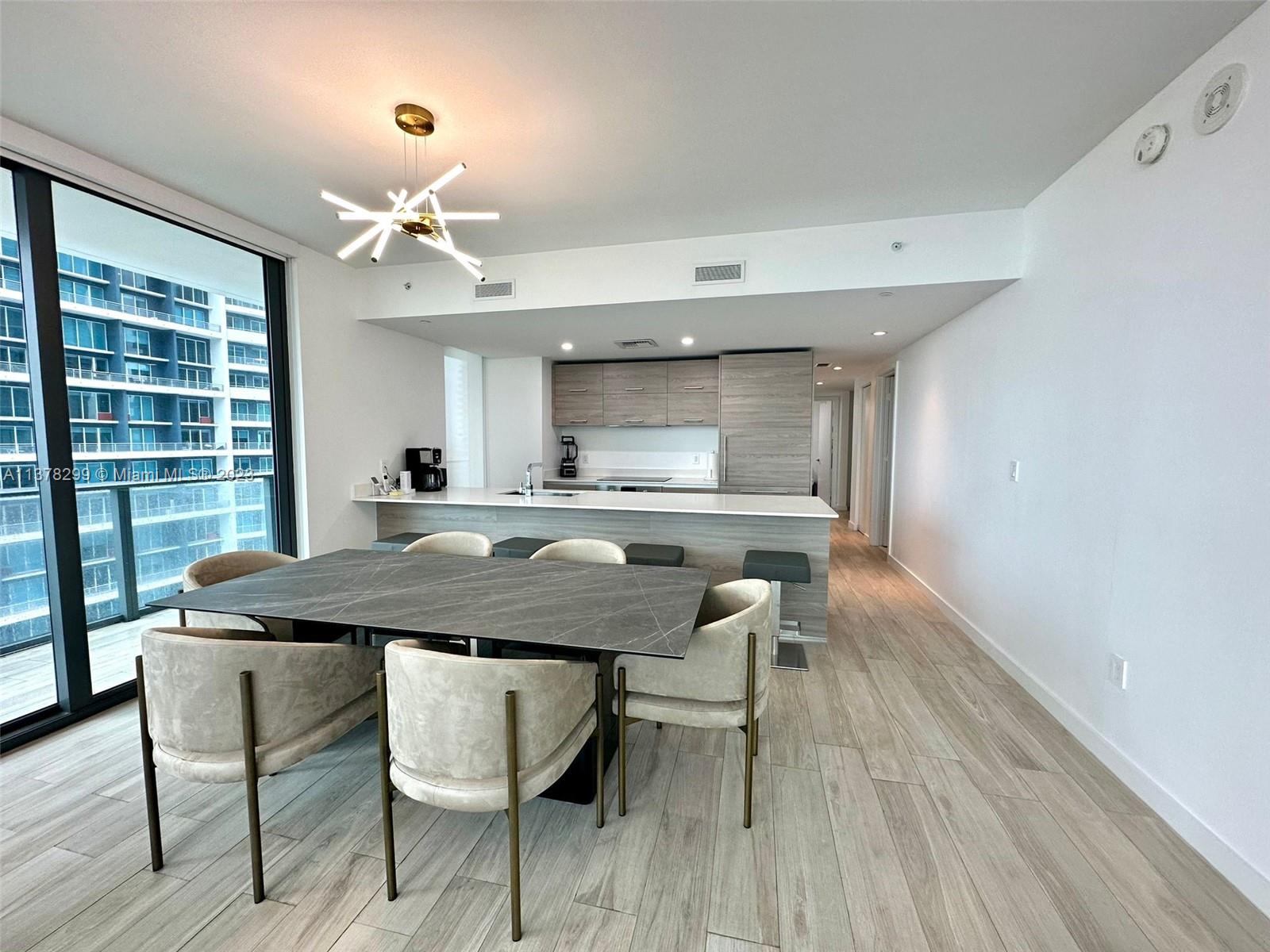 Brickell Miami, FL 33130 - Photo 5 of 17 a view of a dining room with furniture window and wooden floor