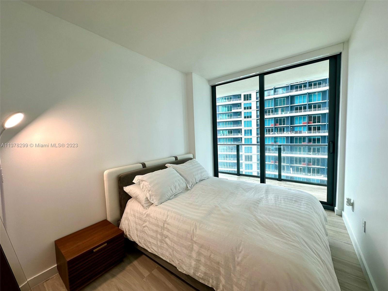 Brickell Miami, FL 33130 - Photo 9 of 17 a large bed sitting in a bedroom next to a window