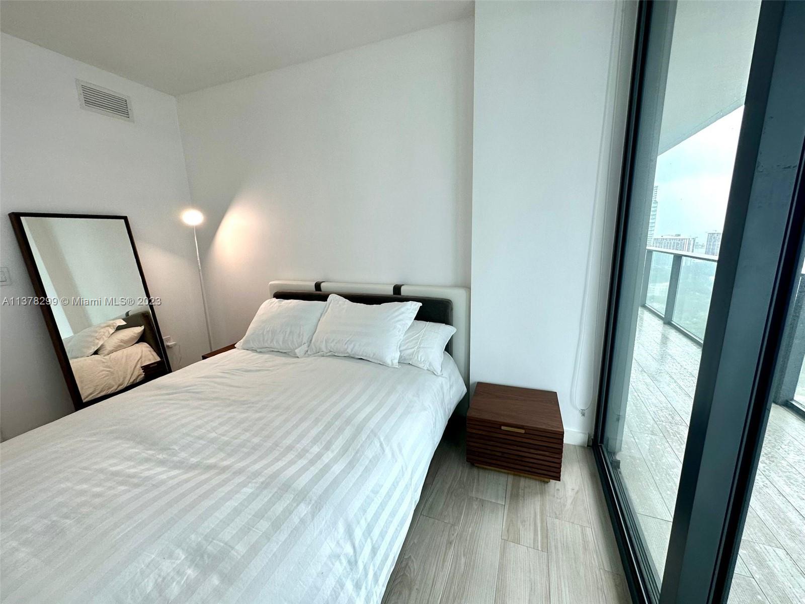 Brickell Miami, FL 33130 - Photo 10 of 17 a bedroom with a bed and a mirror