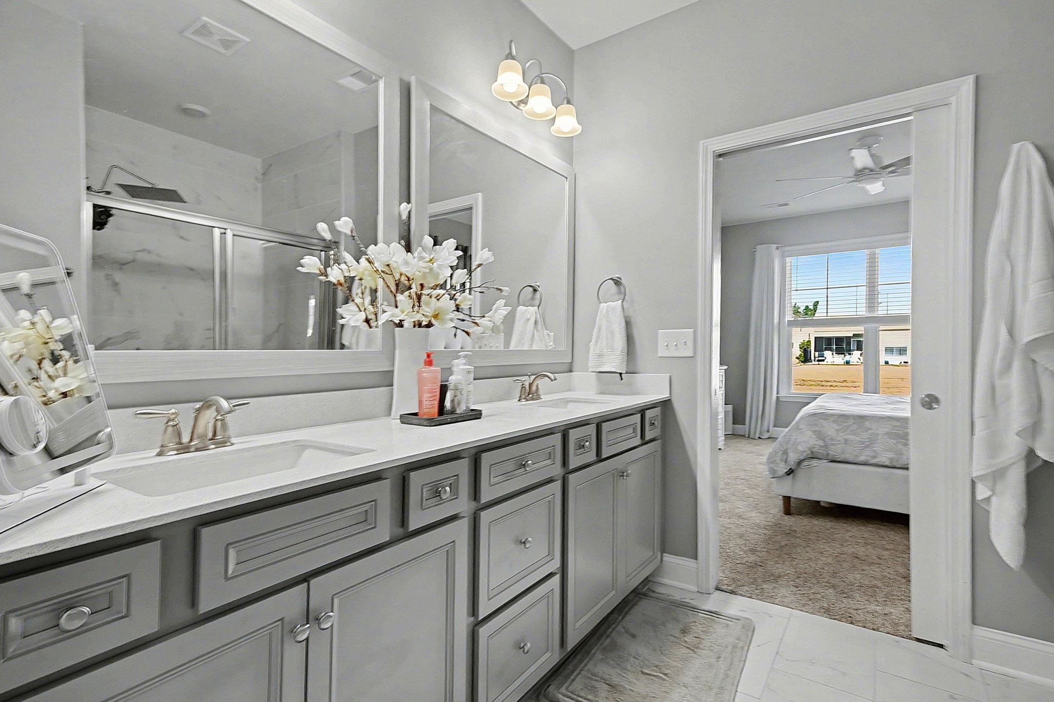 5830 Cremona Drive Myrtle Beach, SC 29577 - Photo 21 of 39 Bathroom with double vanity, a stall shower, ensuite bath, ceiling fan, and light marble finish flooring