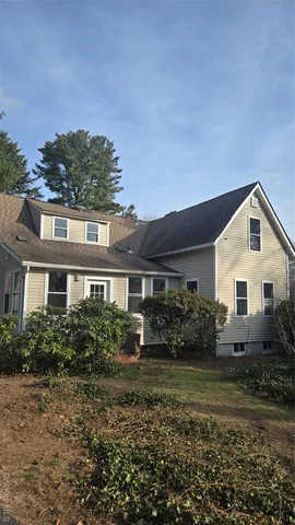 a view of house with a garden