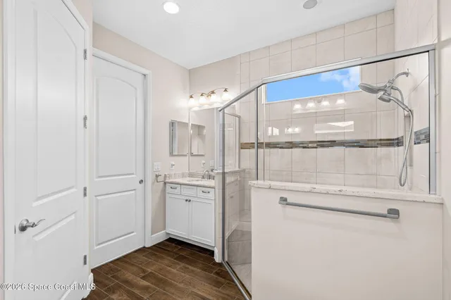 a bathroom with a tub sink and mirror