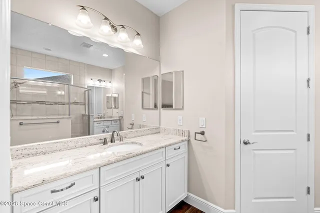 a bathroom with a sink double vanity and a mirror