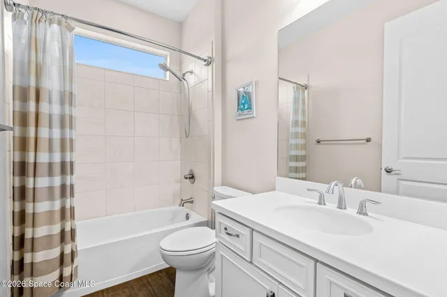 a bathroom with a sink toilet a mirror and shower