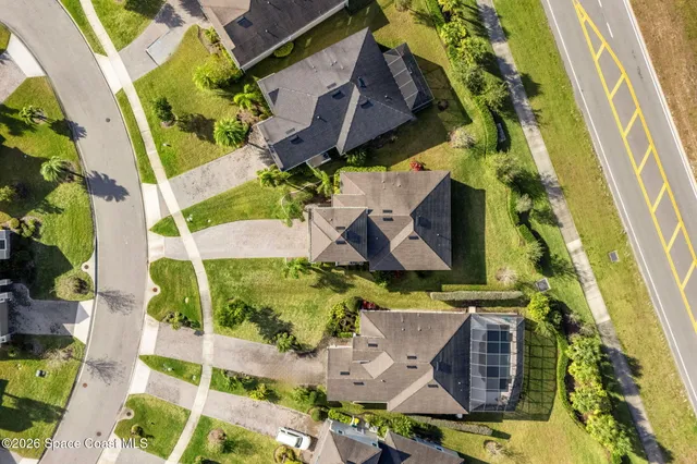 an aerial view of a house with a yard