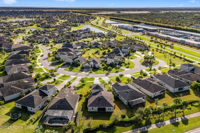 an aerial view of residential houses with outdoor space