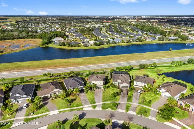 an aerial view of residential building and lake