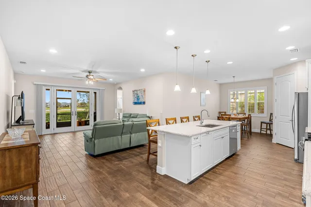 a kitchen with a sink and wooden floor