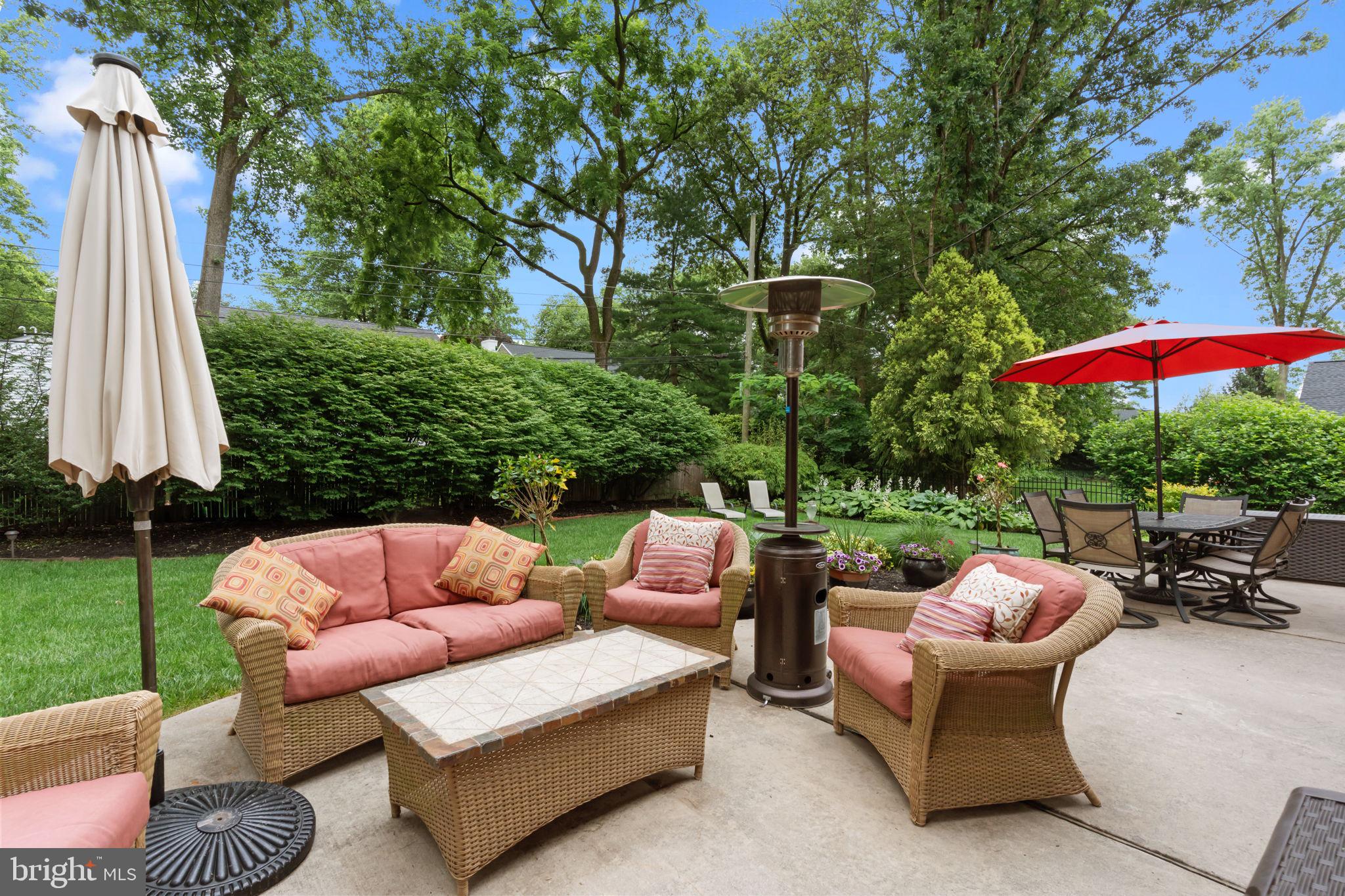 4 Keats Road Yardley, PA 19067 - Photo 58 of 65 a view of patio with couches table and chairs under an umbrella with a fire pit