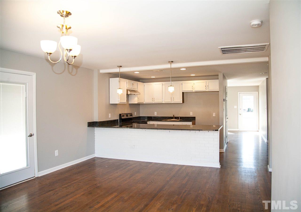 833 Newcombe Road Raleigh, NC 27610 - Photo 11 of 25 a kitchen with stainless steel appliances granite countertop a sink a stove and wooden floor