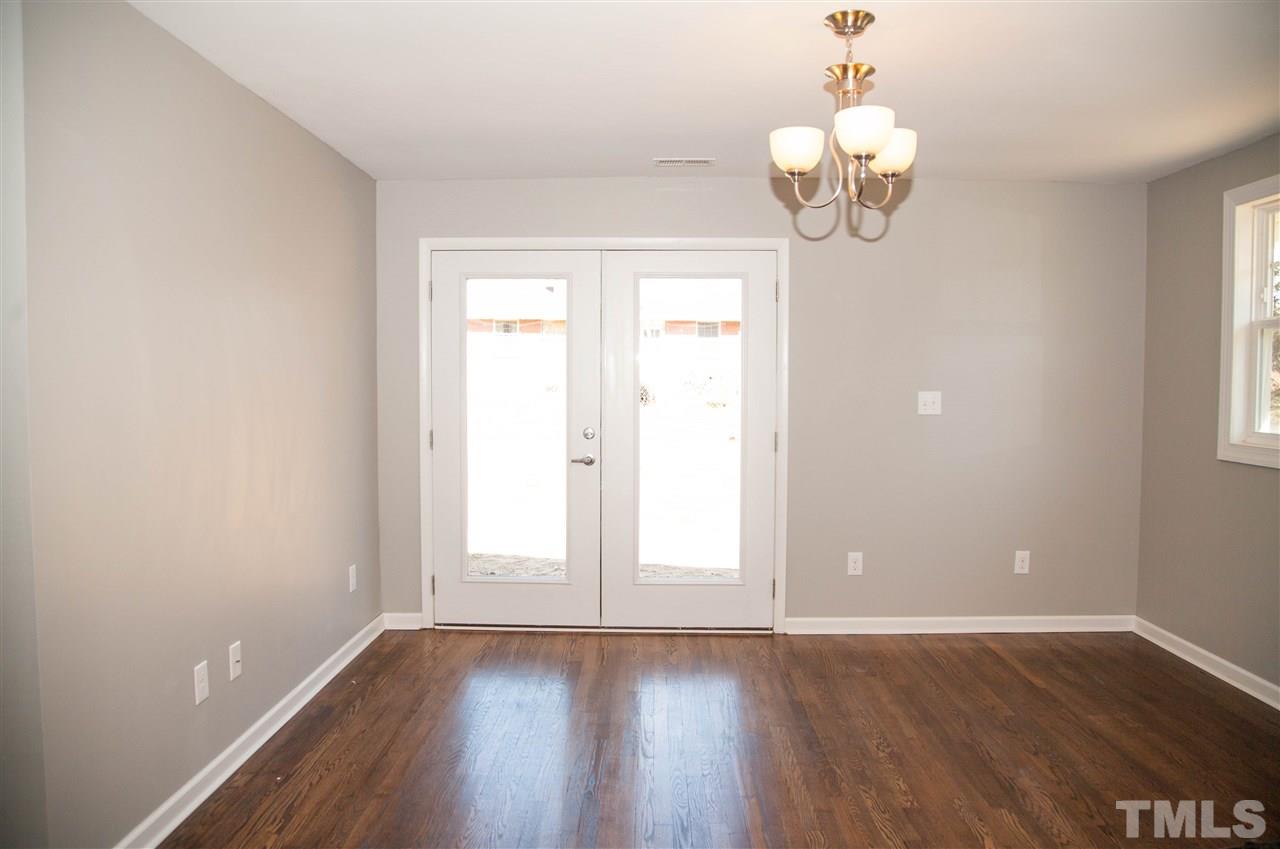 833 Newcombe Road Raleigh, NC 27610 - Photo 12 of 25 an empty room with wooden floor and windows