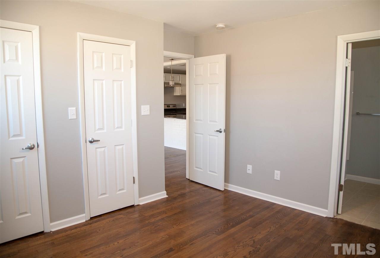 833 Newcombe Road Raleigh, NC 27610 - Photo 13 of 25 a view of an empty room with wooden floor