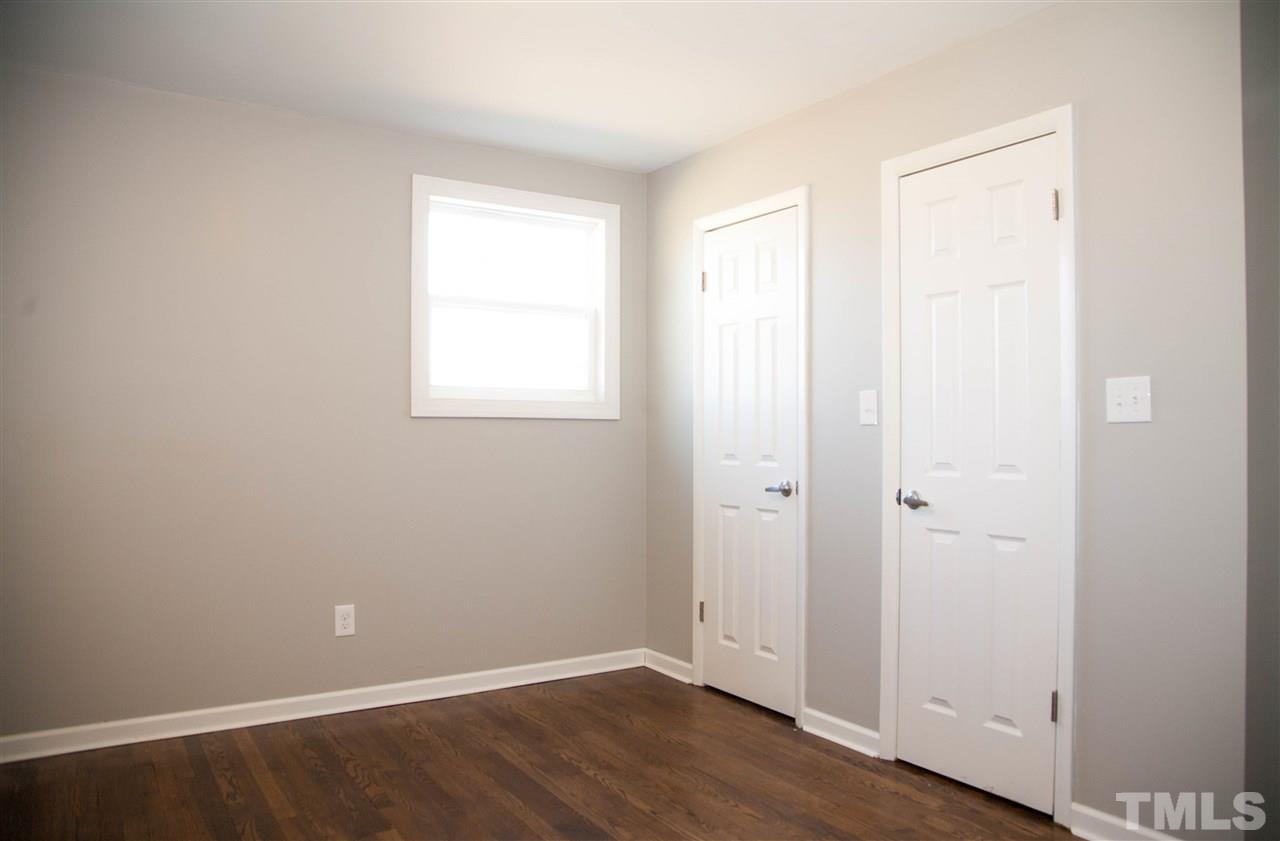 833 Newcombe Road Raleigh, NC 27610 - Photo 14 of 25 an empty room with wooden floor and a window