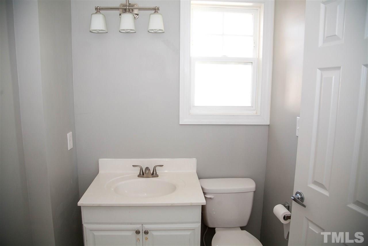 833 Newcombe Road Raleigh, NC 27610 - Photo 15 of 25 a bathroom with a toilet sink and mirror