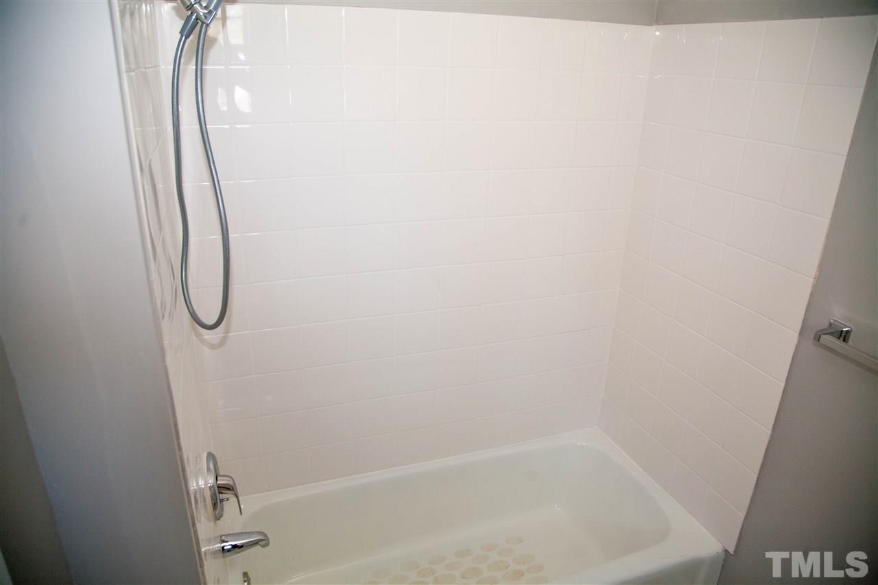 833 Newcombe Road Raleigh, NC 27610 - Photo 16 of 25 a bathroom with a glass shower door