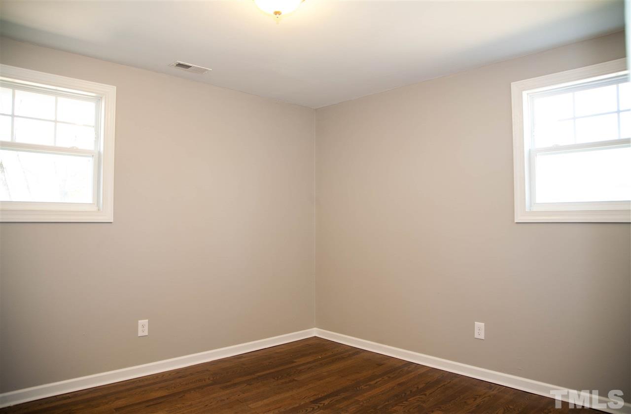 833 Newcombe Road Raleigh, NC 27610 - Photo 19 of 25 an empty room with wooden floor and window
