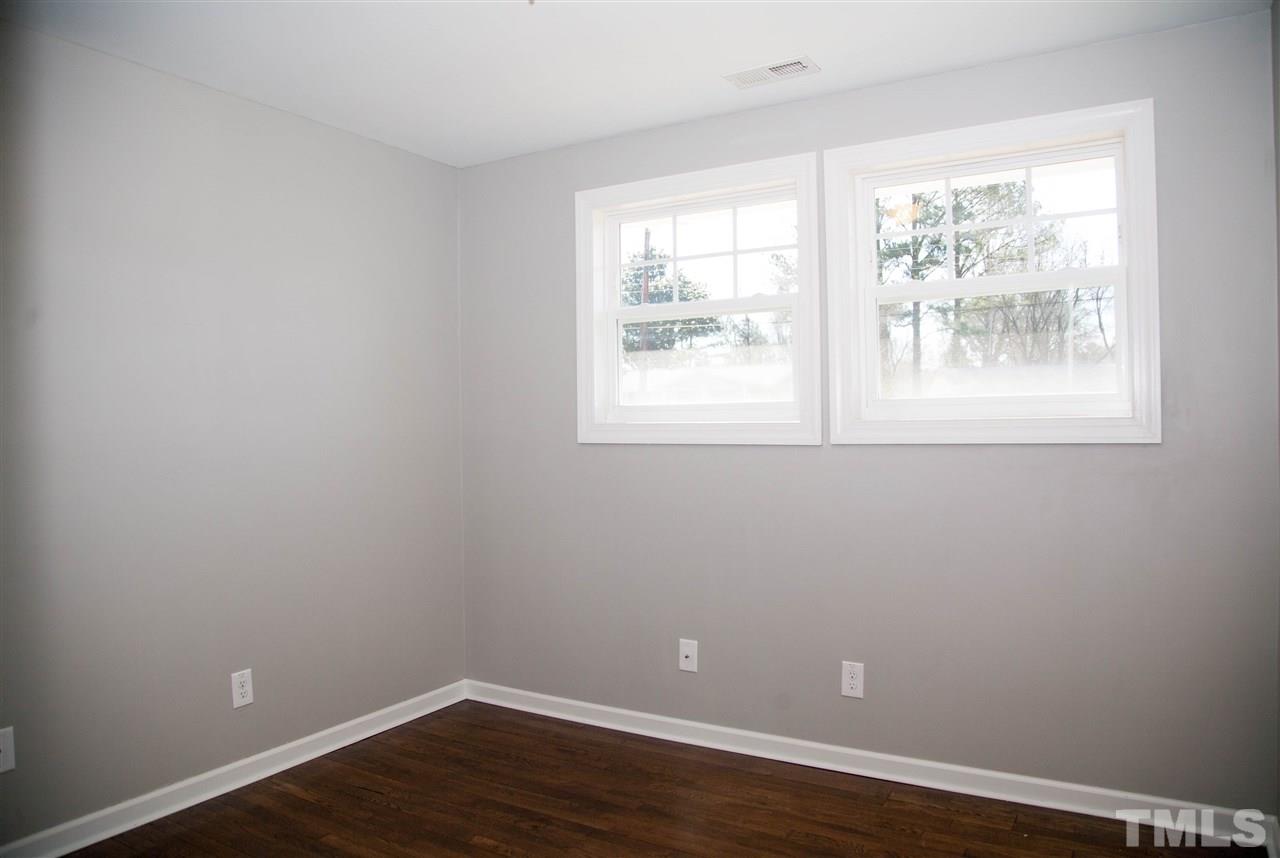 833 Newcombe Road Raleigh, NC 27610 - Photo 20 of 25 an empty room with wooden floor and windows