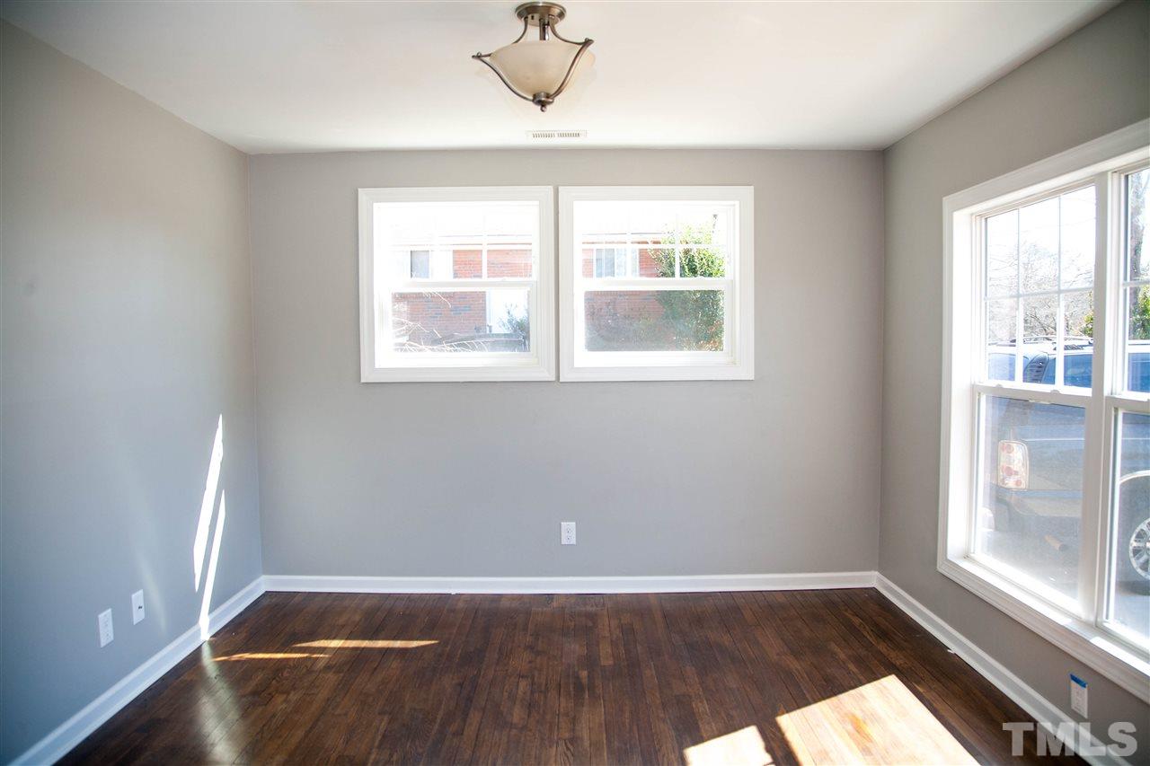 833 Newcombe Road Raleigh, NC 27610 - Photo 3 of 25 an empty room with wooden floor and windows
