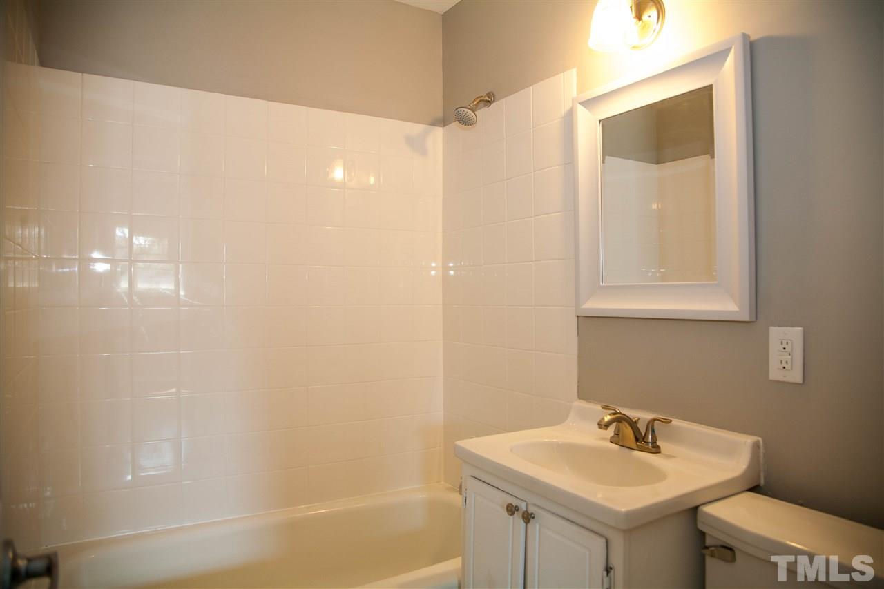 833 Newcombe Road Raleigh, NC 27610 - Photo 21 of 25 a bathroom with a sink a toilet and shower