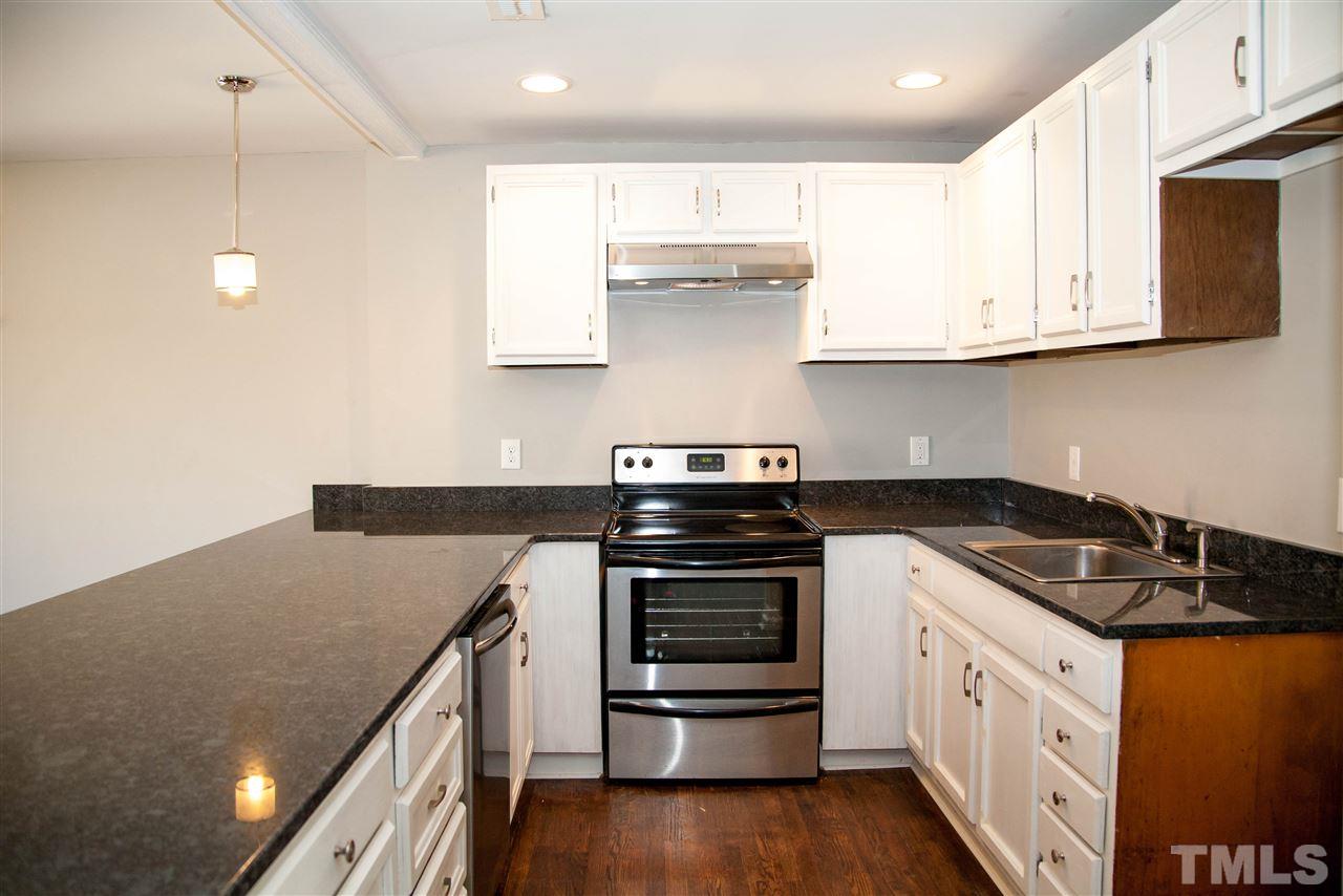833 Newcombe Road Raleigh, NC 27610 - Photo 5 of 25 a kitchen with stainless steel appliances granite countertop a stove a sink and a microwave