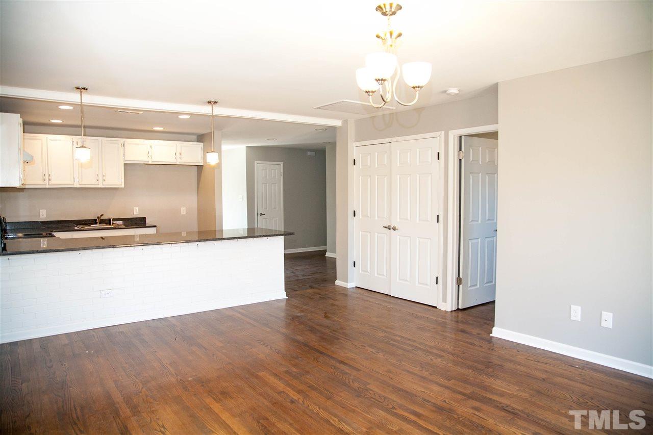 833 Newcombe Road Raleigh, NC 27610 - Photo 9 of 25 a view of kitchen with granite countertop window and white cabinets