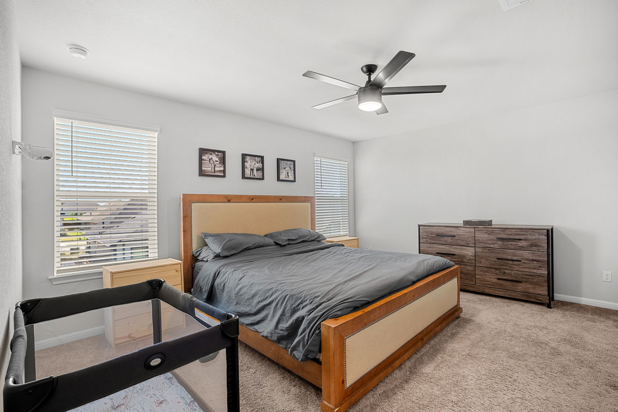 148 Hidalgo Lane Elgin, TX 78621 - Photo 23 of 38 Relax in this tranquil bedroom, featuring soft carpet, a contemporary ceiling fan, and abundant natural light.