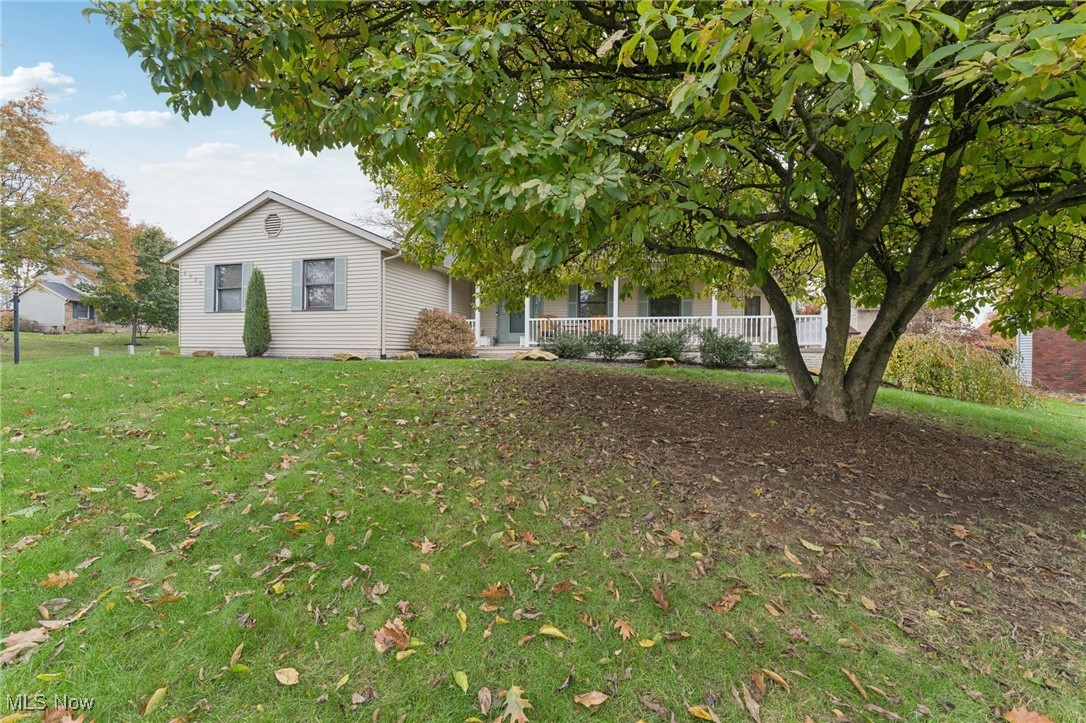 6930 Firestone Road Northeast Canton, OH 44721 - Photo 45 of 49 View of front of property featuring a porch and a front lawn