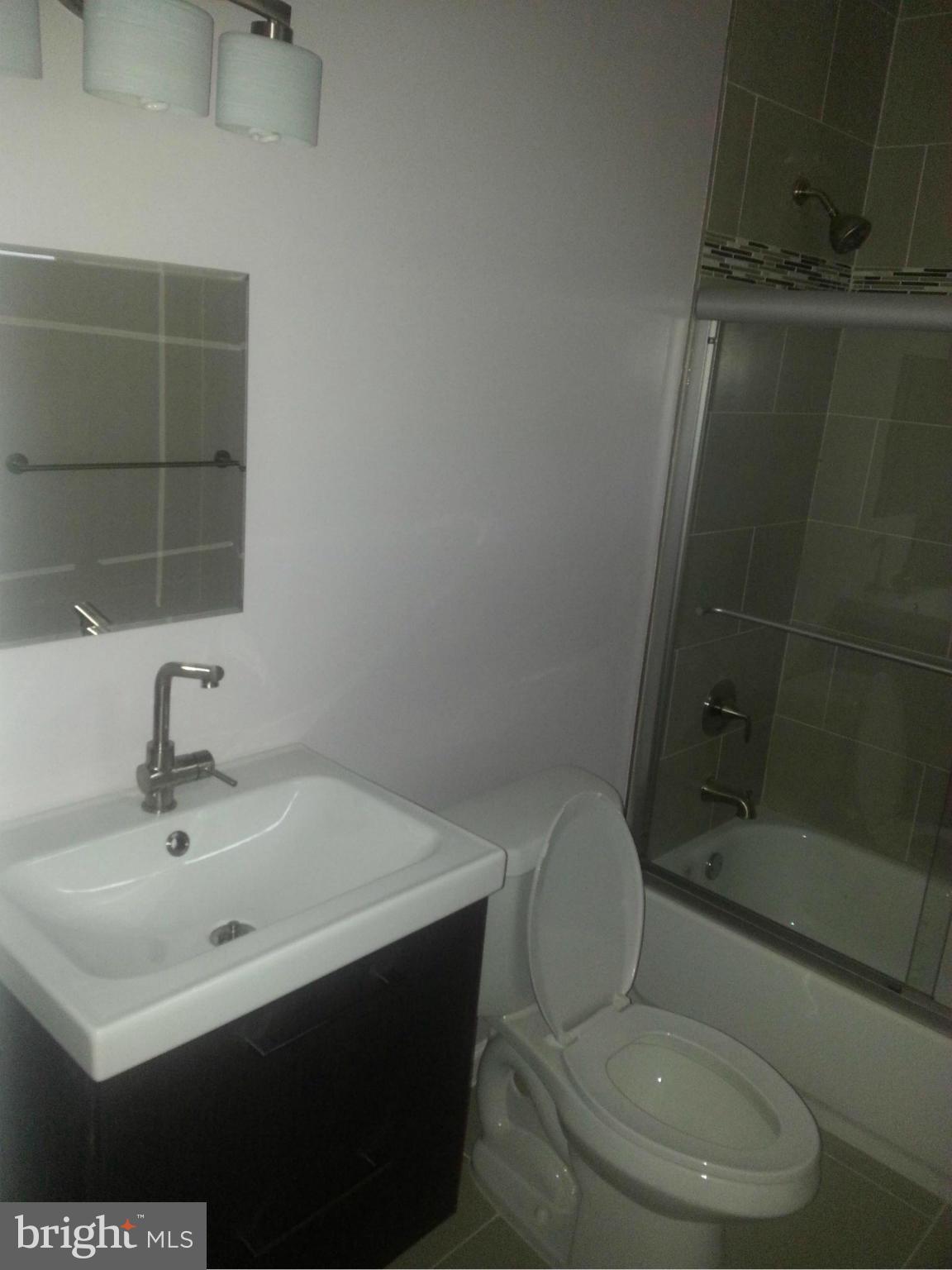 3300 Northbrook Road Pikesville, MD 21208 - Photo 14 of 20 a bathroom with a sink toilet and shower