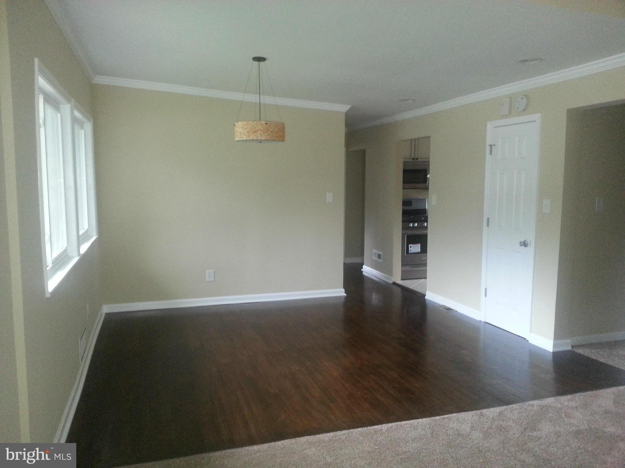 3300 Northbrook Road Pikesville, MD 21208 - Photo 3 of 20 an empty room with wooden floor and windows
