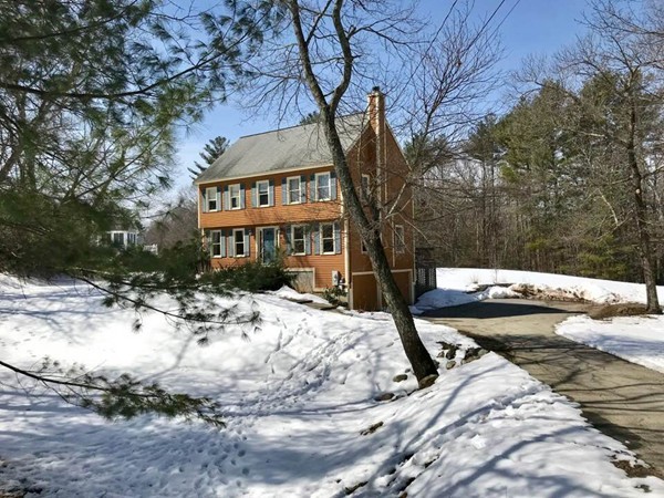 a view of a white house with a yard covered in snow
