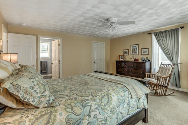 28 Turnpike Road Ipswich, MA 01938 - Photo 14 of 28 a spacious bedroom with a bed a table and chair