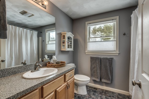 28 Turnpike Road Ipswich, MA 01938 - Photo 15 of 28 a bathroom with a granite countertop sink toilet and mirror