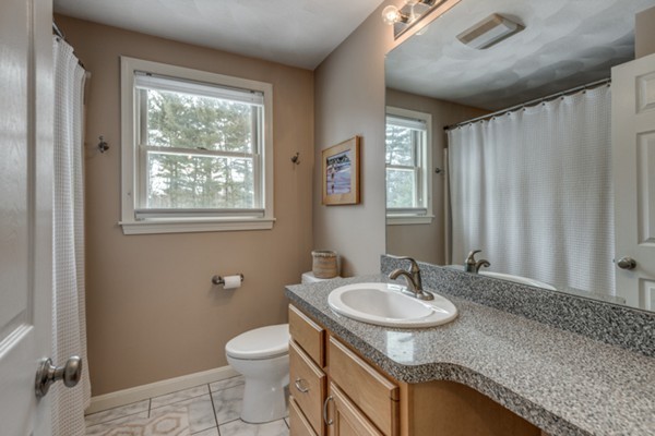 28 Turnpike Road Ipswich, MA 01938 - Photo 17 of 28 a bathroom with a granite countertop sink toilet and a mirror