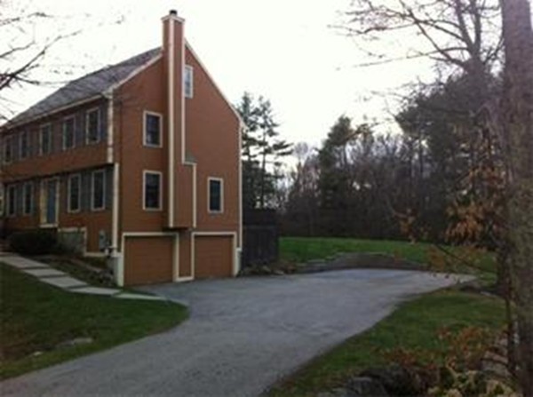 28 Turnpike Road Ipswich, MA 01938 - Photo 27 of 28 a backyard of a house with large trees and wooden fence