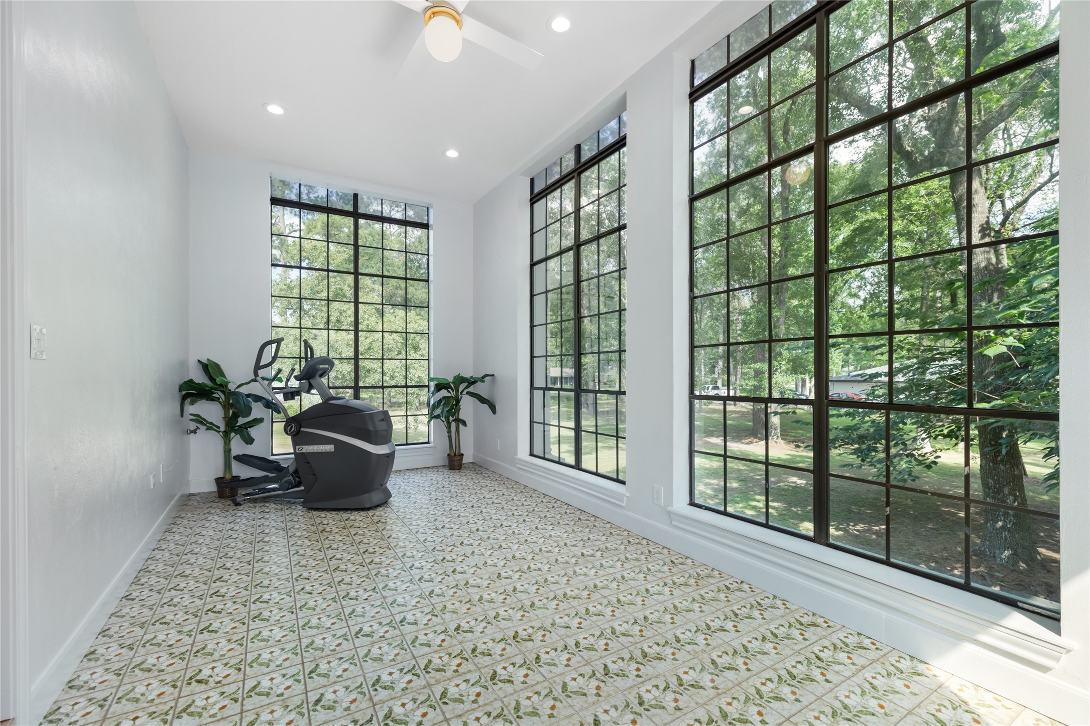 17003 Creeksouth Road Houston, TX 77068 - Photo 16 of 49 Bathed in natural light from floor-to-ceiling windows, this stunning flex room offers breathtaking views of the sprawling grounds, creating an inspiring and tranquil atmosphere. Whether used as a fitness space, creative studio, or quiet retreat, it’s a place where productivity and peace effortlessly coexist.