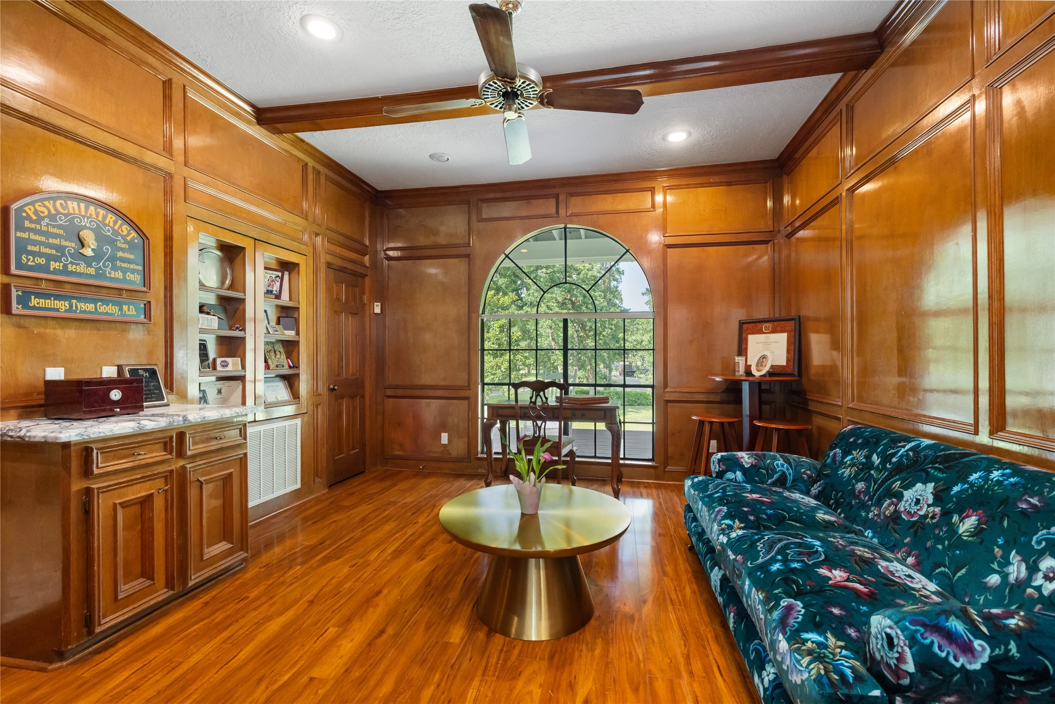 17003 Creeksouth Road Houston, TX 77068 - Photo 18 of 49 A stately retreat featuring large windows that fill the space with natural light and rich wood-paneled walls. Complete with built-in shelves and a dry bar, this elegant office blends functionality with timeless sophistication.