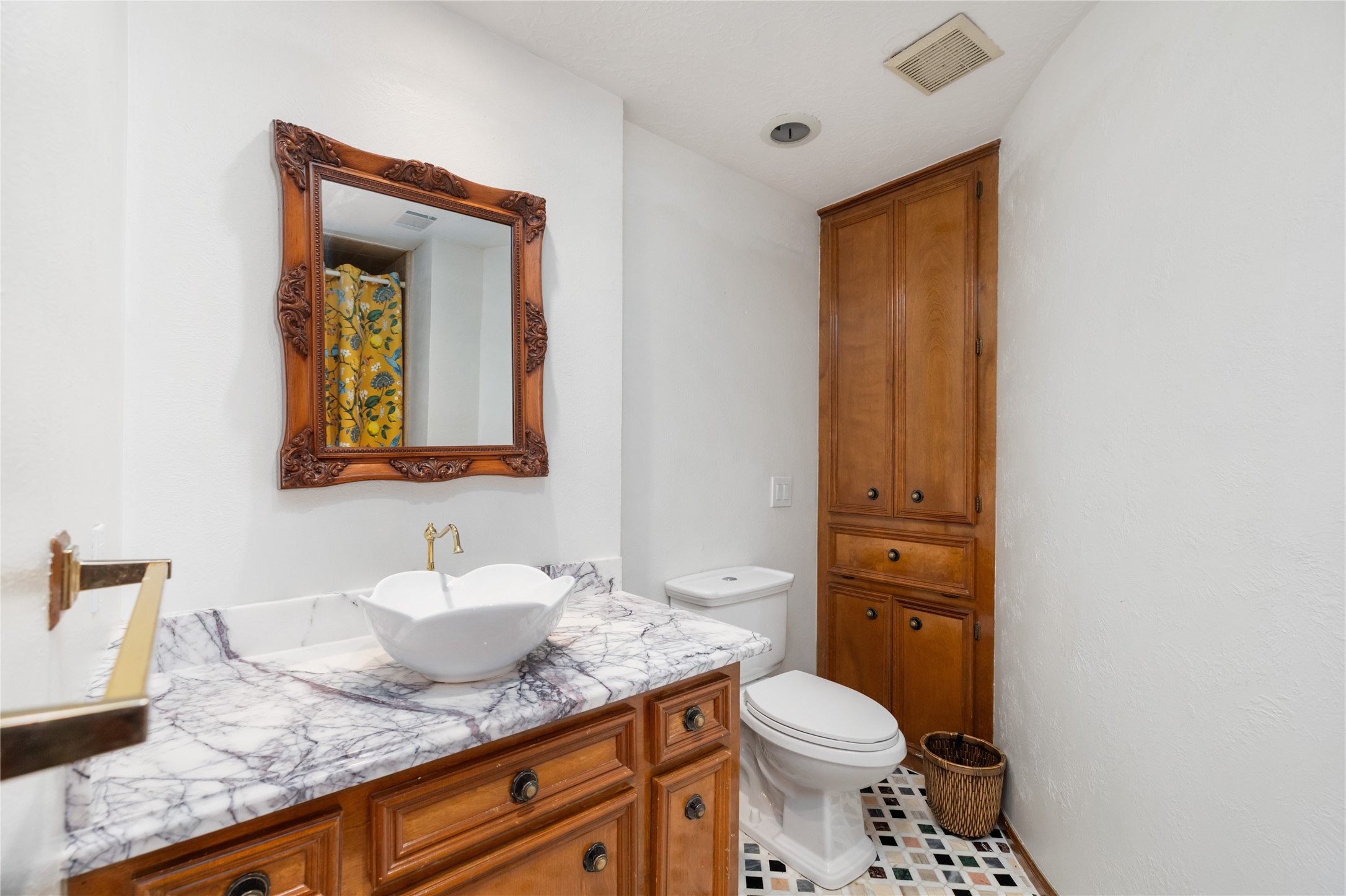 17003 Creeksouth Road Houston, TX 77068 - Photo 19 of 49 This elegant bath features marble sinks atop natural wood cabinetry, a sleek modern sink and faucet, and stylish tile flooring—combining timeless materials with contemporary design for a refined finish.