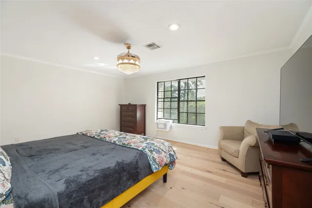 a bedroom with a bed and window