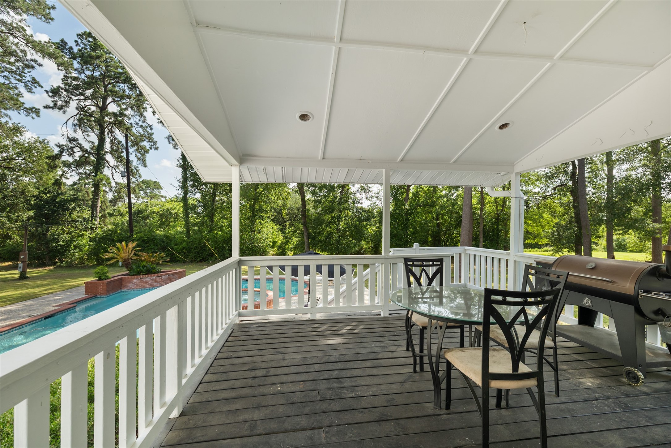 17003 Creeksouth Road Houston, TX 77068 - Photo 38 of 49 Seamlessly connected to the kitchen, this covered deck makes indoor-outdoor entertaining effortless. Whether hosting guests or enjoying a quiet evening, it’s the perfect spot to gather, dine, and take in poolside views.