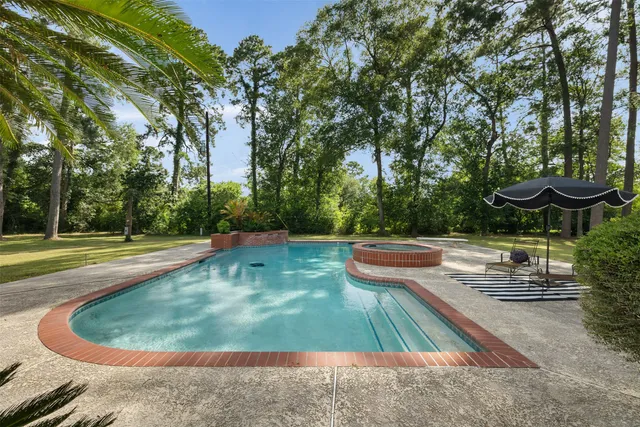 a view of a swimming pool with a yard