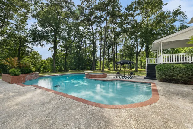 a view of a swimming pool with a patio