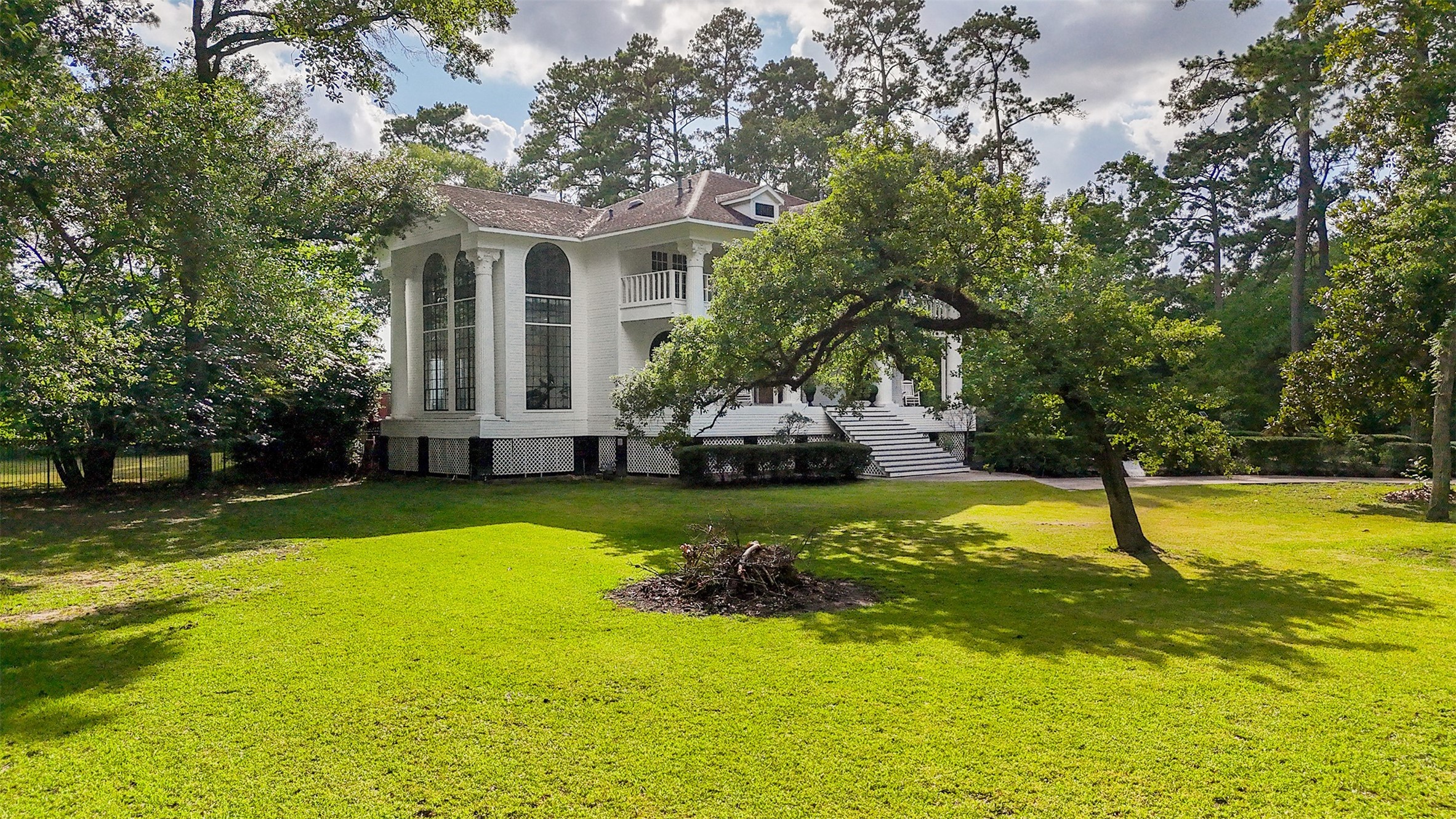 17003 Creeksouth Road Houston, TX 77068 - Photo 4 of 49
From this angle, the estate’s grandeur comes fully into view. The wide-open lawn emphasizes the home’s impressive scale and offers a sweeping look at its timeless architectural presence. A truly breathtaking first impression from every angle.