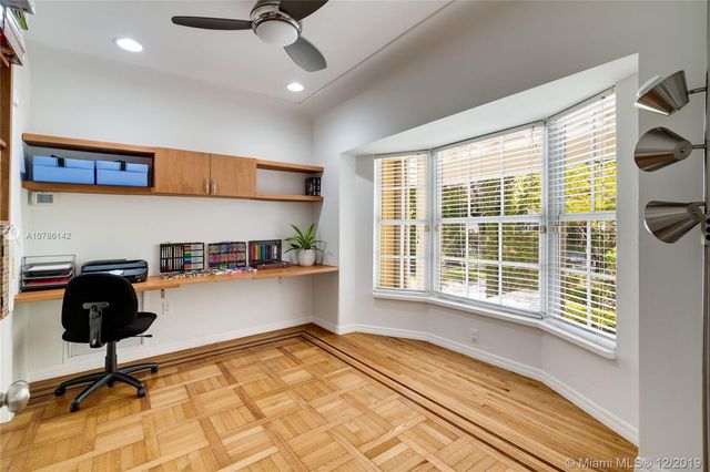 a kitchen with a sink a window and cabinets