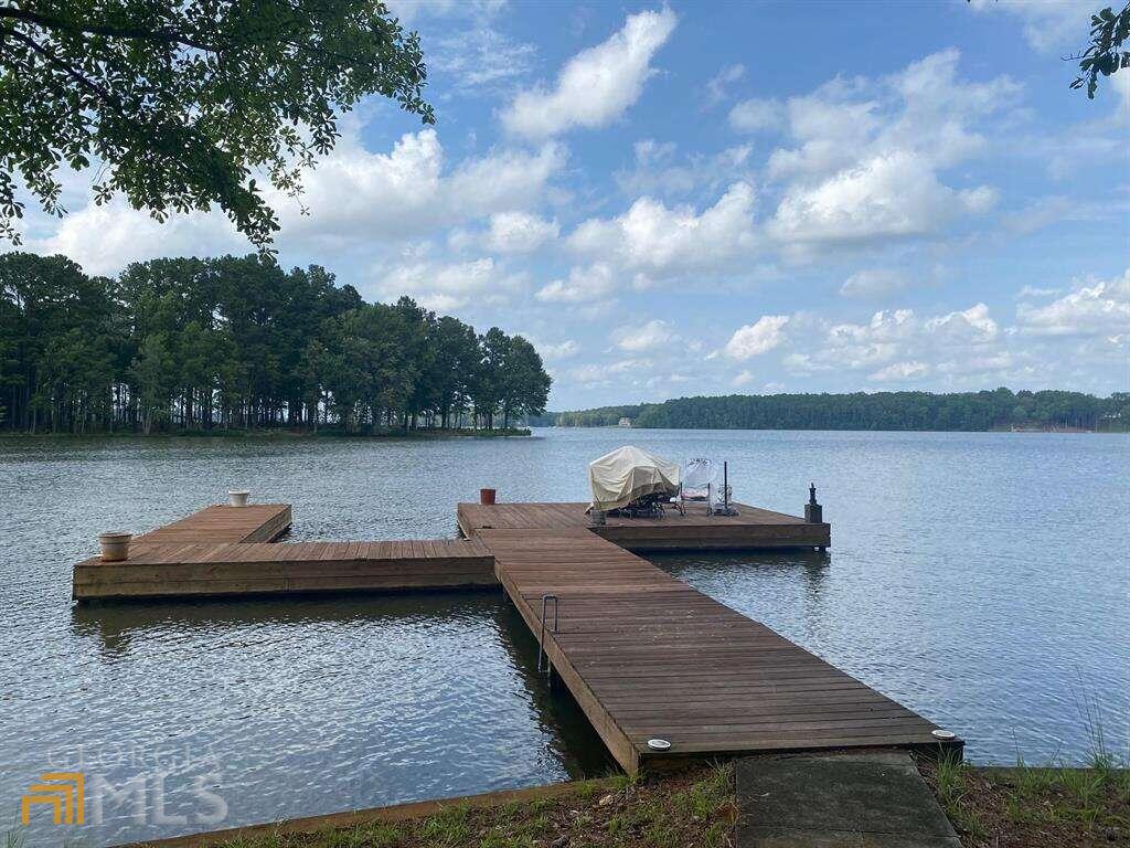 Lot 3 Woods Cove Road Buckhead, GA 30625 - Photo 1 of 1 a view of a lake with lawn chairs and a barbeque