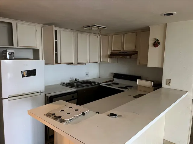 a kitchen with a stove and a refrigerator