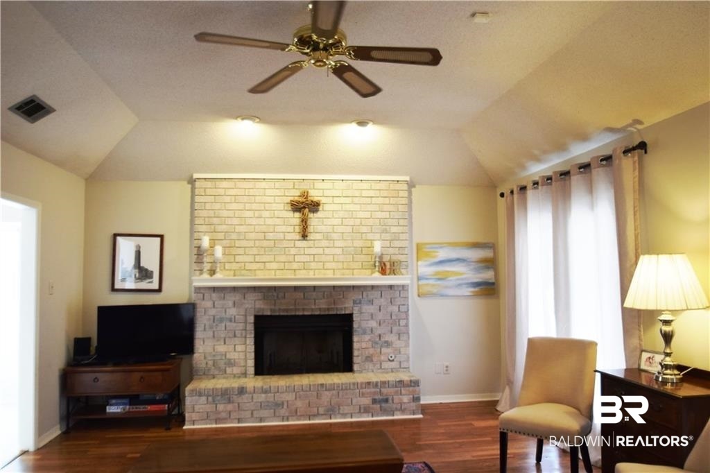 852 West Briar Court Mobile, AL 36609 - Photo 4 of 40 Family room w/hardwood & wood burning fireplace.