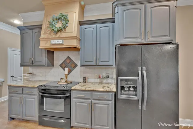 a kitchen with sink refrigerator and cabinets